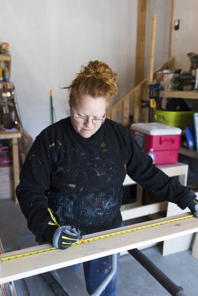 woman building outdoor bench
